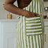 the side of a green apron with white stripes