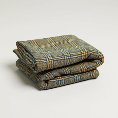 Navy and yellow blanket folded throw blanket plaid design