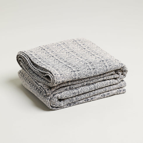 Grey and white boucle jacquard throw blanket folded up