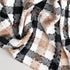 beige, black, and white throw blanket close up to show detailed patten and colors