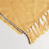 acrylic yellow throw blanket displaying tassels as a pale yellow