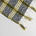 yellow and black plaid check throw blanket corner showing tassels and yellow color