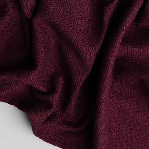 soft maroon colored throw blanket with hemmed edges