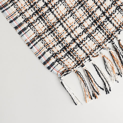 cream and black check throw blanket displayed to show the tassels and brown colors