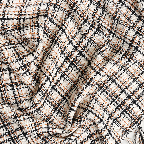 cream white, black, and brown, large plaid throw blanket twisted to show texture and colors