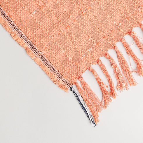 fancy orange cotton blend throw blanket displayed to show its eyelash tassel