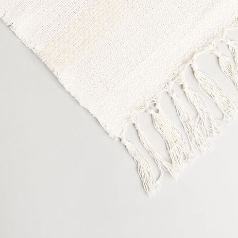 detailed cream colored throw blanket with unique patterns and tassels