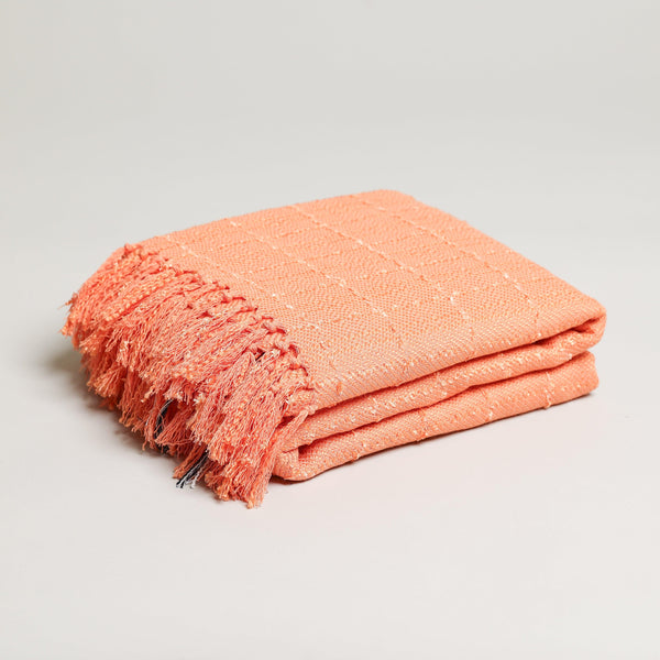 subtle tweed orange throw blanket with eyelash tassel folded up