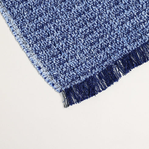 close up image of boucle's blue and purple fuzzy soft throw blanket