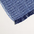close up image of boucle's blue and purple fuzzy soft throw blanket