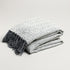 grey herringbone patterned white and black throw blanket