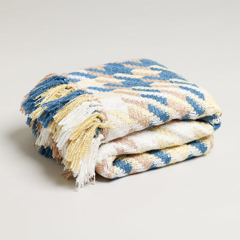 yellow white and blue folded throw blanket with tassels made from acrylic