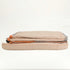 Folded tan bed set with a white background with an orange and grey rim