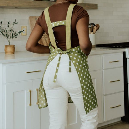 back of green apron with white polka dots