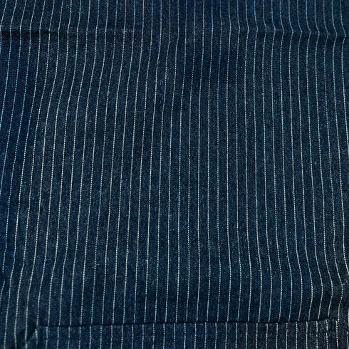 close up of denim apron with white stripes