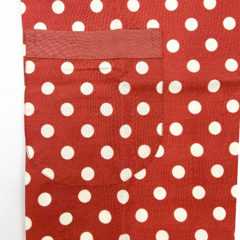 close up of red apron with white polka dots