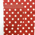 close up of red apron with white polka dots