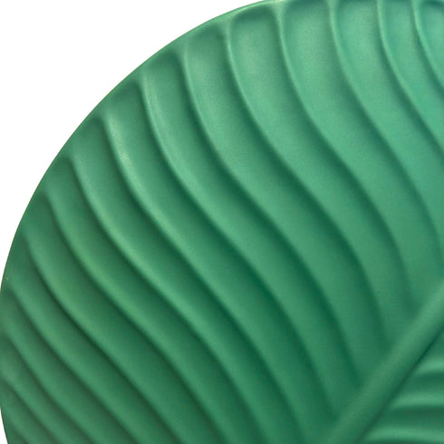 close up view to the left hand side of the same dark green leaf vase