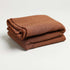 wool and acrylic brown colored throw blanket folded up nicely