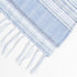 light periwinkle summer blanket displayed to show the blue tassels