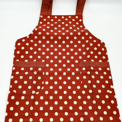 red apron with white polka dots close up
