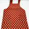 red apron with white polka dots close up