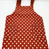 red apron with white polka dots close up