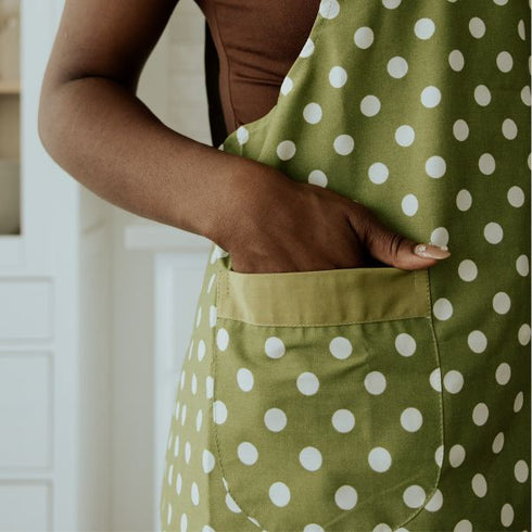 side of green apron with white polka dots