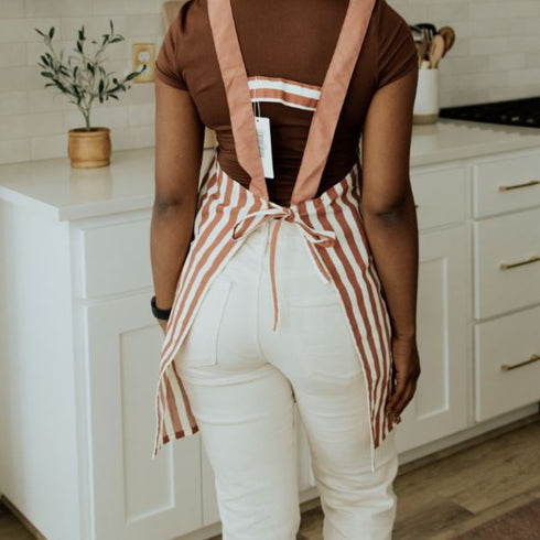 the back of red apron with white stripes