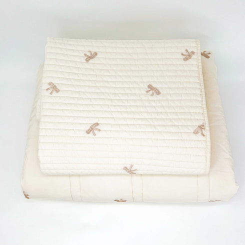 white nursery set with bows up top