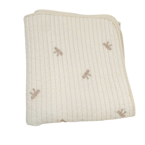 white quilt with bows folded